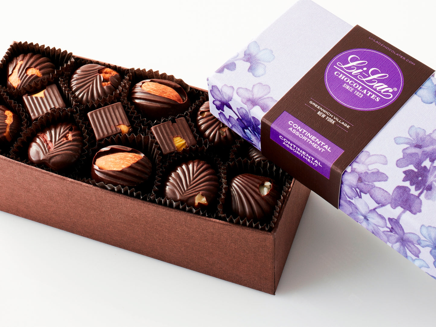 A rectangular box of chocolate with a brown base and a purple lid with watercolor lilac motifs.