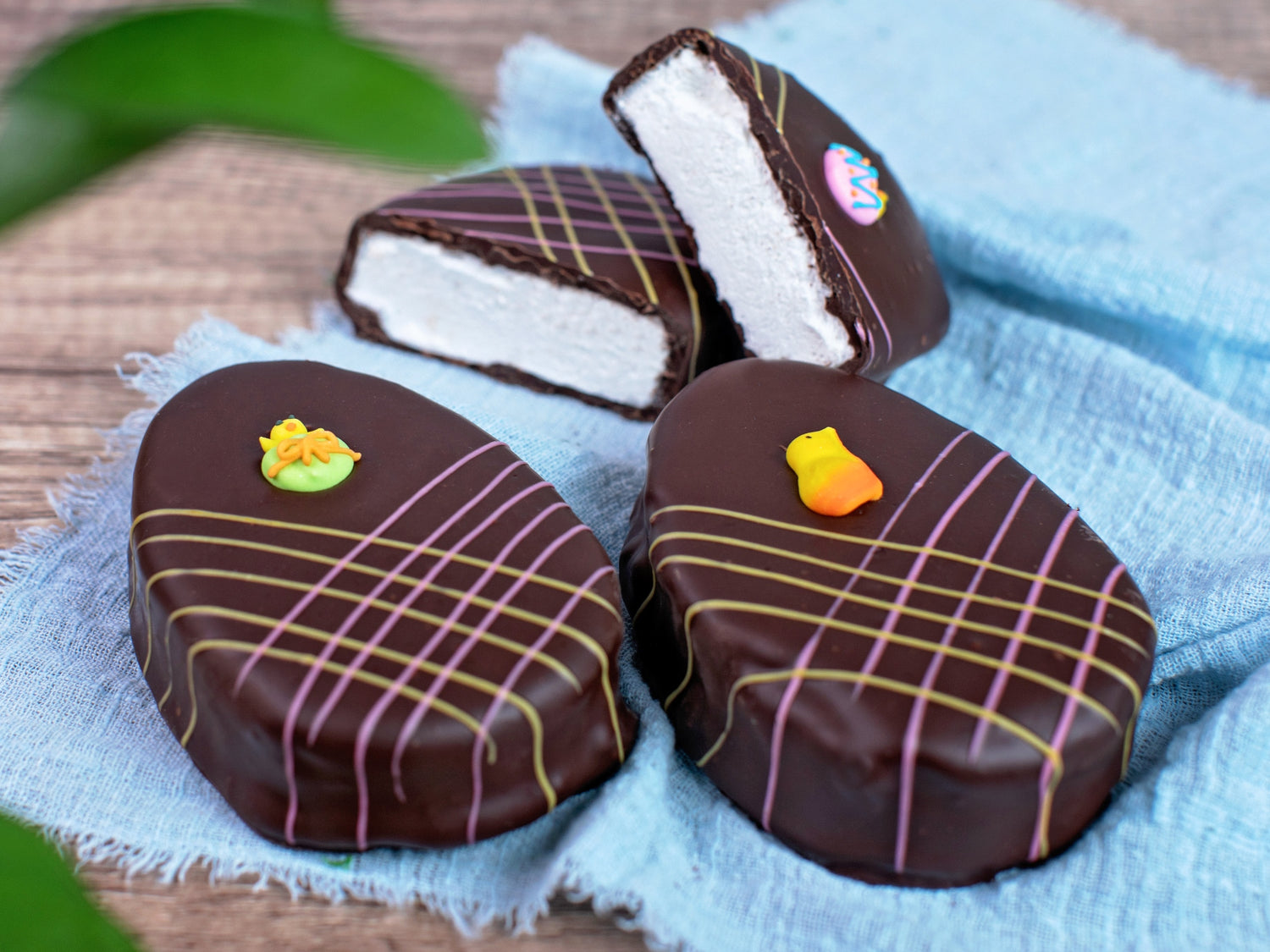 oversized marshmallow eggs artfully decorated with colorful drizzle and sugar motifs.