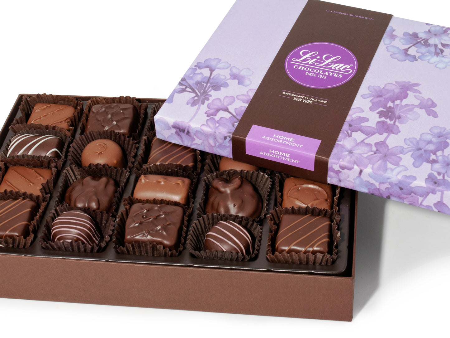 A large rectangular box of chocolate with a brown base and a purple lid with watercolor lilac motifs.