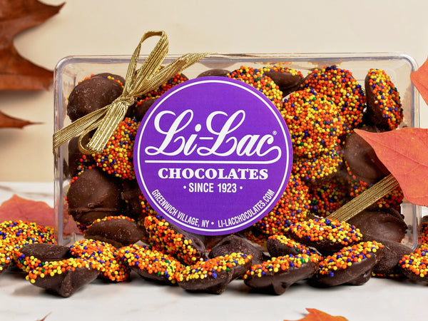 Thanksgiving colored Nonpareils in a clear box with a Li-Lac Chocolate round sticker on the lid.