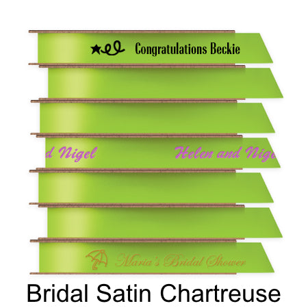 A stack of seven spools of shiny chartreuse satin ribbon with custom messages printed on them in different colors.