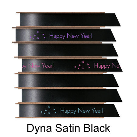 A stack of seven spools of shiny black satin ribbon with custom messages printed on them in different colors.