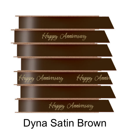 A stack of seven spools of shiny brown satin ribbon with custom messages printed on them in different colors.