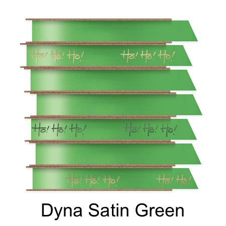 A stack of seven spools of shiny green satin ribbon with custom messages printed on them in different colors.
