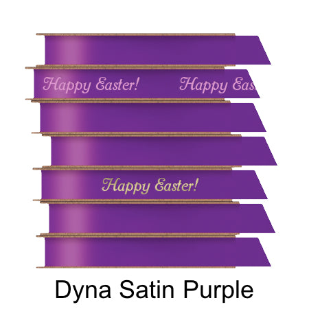 A stack of seven spools of shiny purple satin ribbon with custom messages printed on them in different colors.