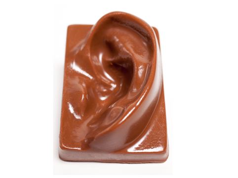 A rectangular chocolate bar has a three-dimensional human ear shaped top.