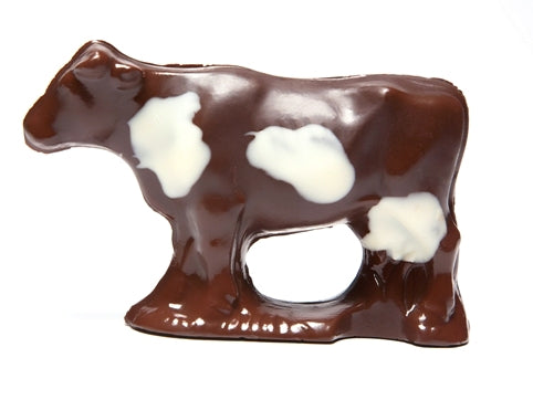 a cow shaped chocolate with white chocolate spots