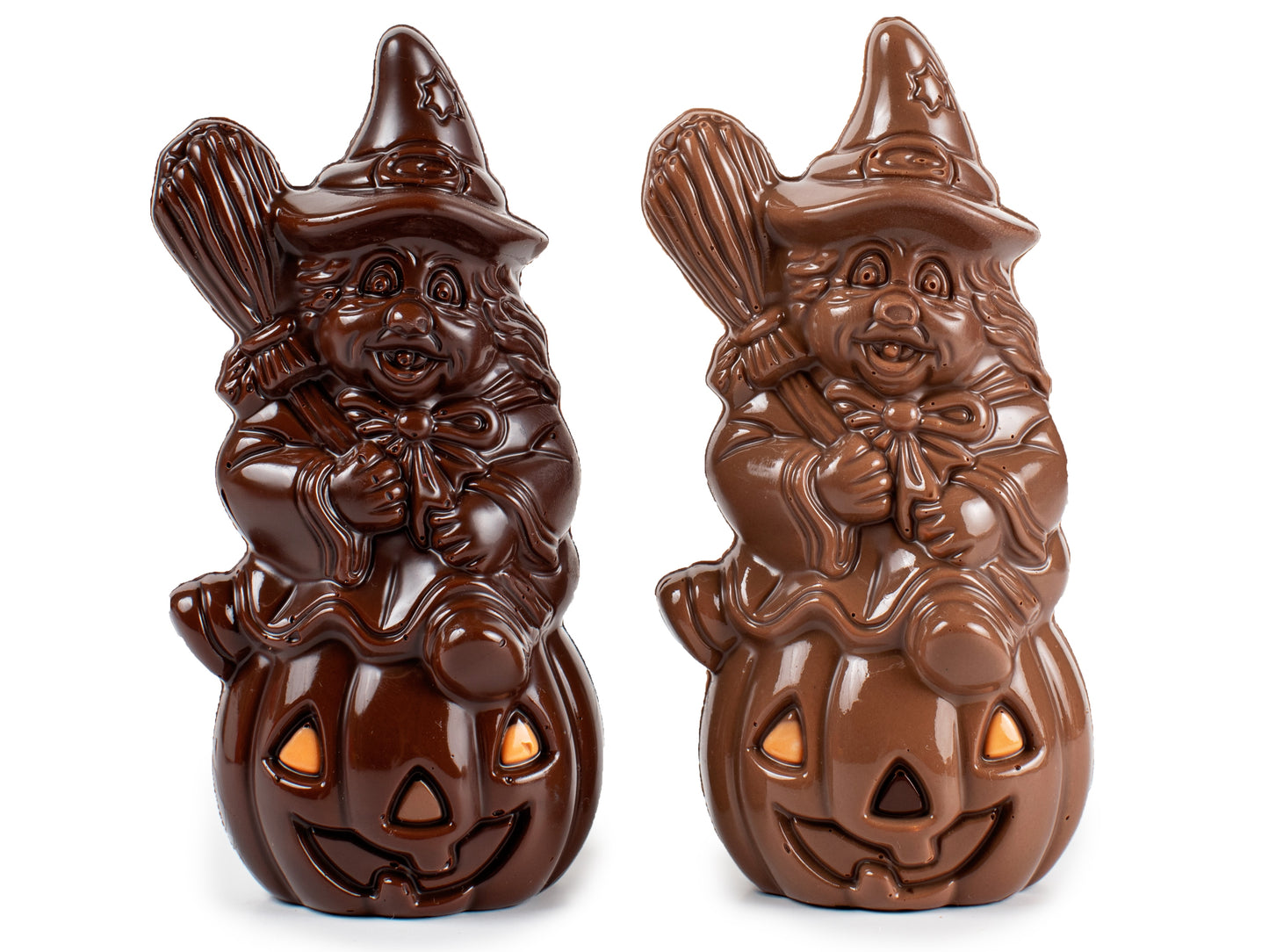 A chocolate witch holding a broomstick is sitting on a pumpkin