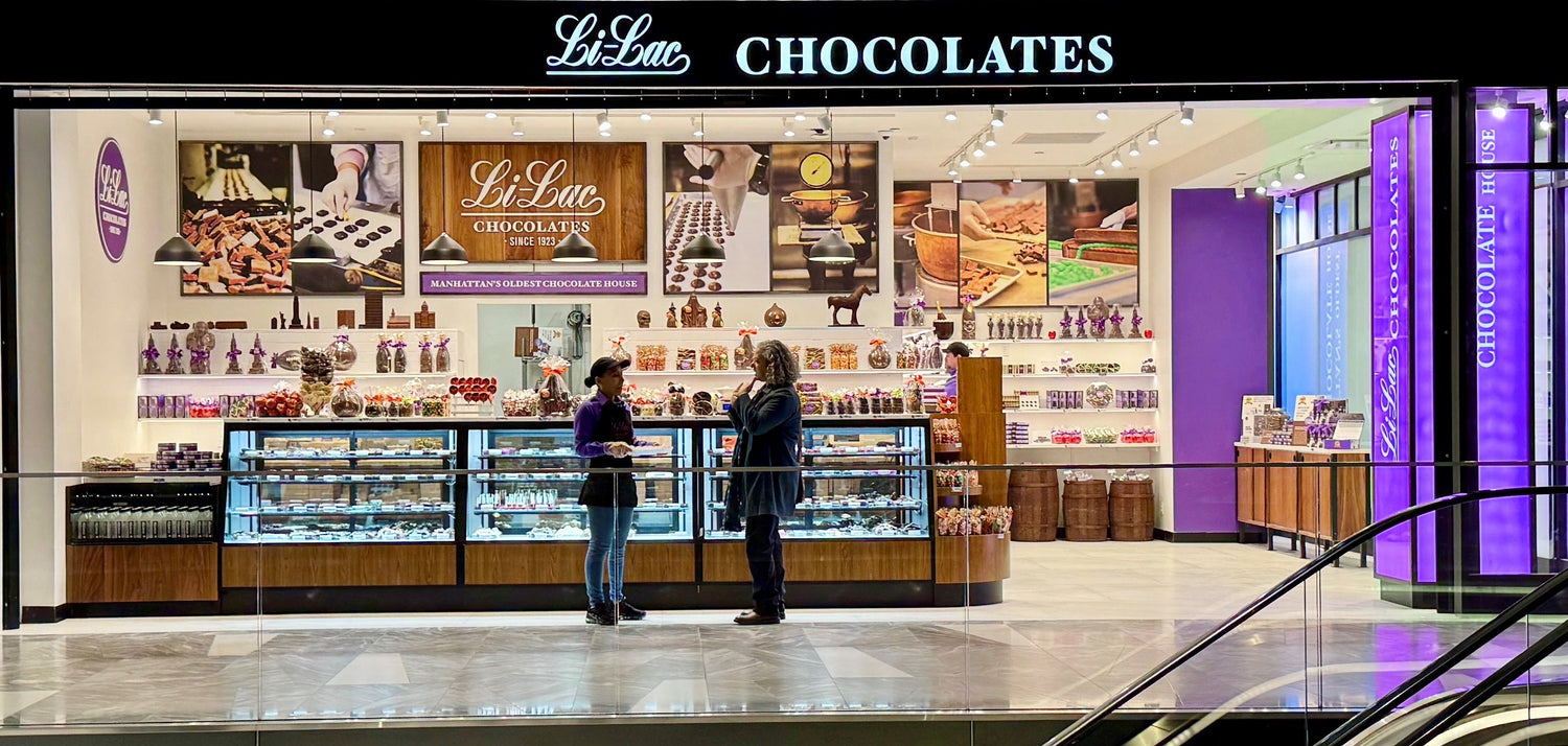 This is the Li-Lac Chocolate store with a store associate talking with a customer