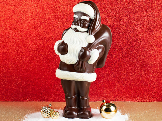 A large chocolate molded Santa Claus holds a toy sack over his shoulder.