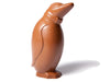 An adorable penguin molded from chocolate tilts his head, wearing a little bowtie.