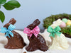 three chocolate place setting bunnies with Easter bows around their necks.