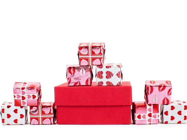 9 assorted valentine-wrapped chocolate "presents" artfully displayed.