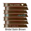 A stack of seven spools of shiny brown satin ribbon with custom messages printed on them in different colors. 
