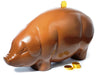 A giant molded chocolate pig has a gold foiled chocolate coin in its back.