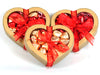 Kraft paper chocolate hearts are filled with foil wrapped chocolate hearts and the box is tied with a festive ribbon. 