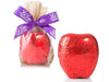 A Big Chocolate molded Apple is wrapped in shiny red foil.