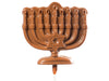 Molded chocolate menorah has a Star of David in the center and is on a lolly stick.