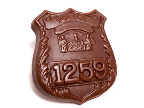 A chocolate molded Police Badge with number 1259 embossed onto it.