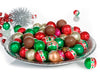 Chocolate Christmas balls are wrapped in red,green and gold foils that look like christmas baubles.