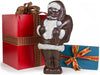 A large chocolate molded Santa Claus holds a toy sack over his shoulder.