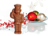 A molded chocolate toy soldier stands at attention, saluting.