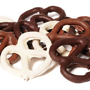 Thin pretzels, enrobed in milk and dark chocolate, are stacked together.