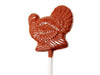 A molded chocolate pop on a stick, shaped like a turkey with it's tail fanned out.